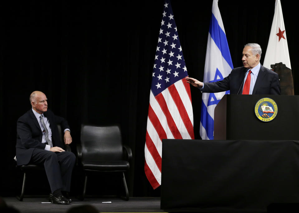 Israeli Prime Minister Benjamin Netanyahu, right, speaks as California Gov. Jerry Brown, left, listens before signing of an agreement to expand cooperation at the Computer History Museum Wednesday, March 5, 2014, in Mountain View, Calif. Netanyahu is visiting California, trading a focus on the geopolitics of the Middle East for a Hollywood screening and visits with Silicon Valley tech entrepreneurs.(AP Photo/Eric Risberg)