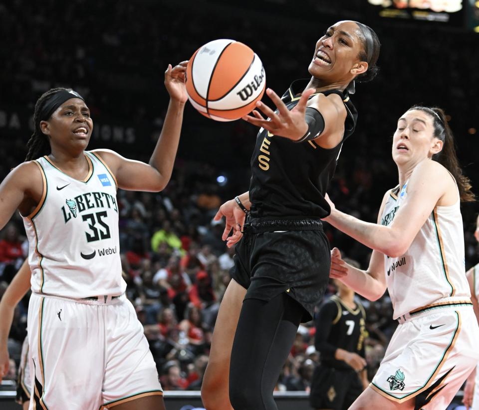 Las Vegas Aces forward A'ja Wilson, center, and New York Liberty forward Jonquel Jones (35) reach for a rebound as Liberty forward Breanna Stewart, right, looks on during Game 2 of the 2023 WNBA Finals.