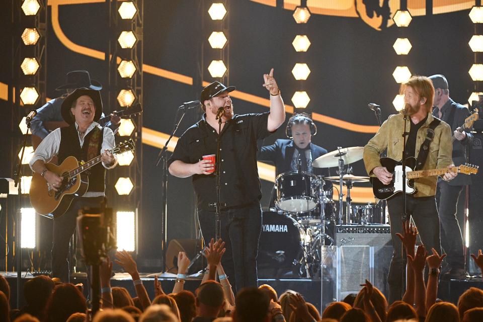 Luke Combs, center, with Kix Brooks, left, and Ronnie Dunn of Brooks & Dunn, perform during the 54TH Academy of Country Music Awards Sunday, April 7, 2019, in Las Vegas, Nev. 