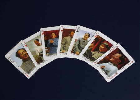 Playing cards bearing images of China's late Chairman Mao Zedong are seen in this photo illustration taken in Beijing, November 26, 2013.REUTERS/Kim Kyung-Hoon