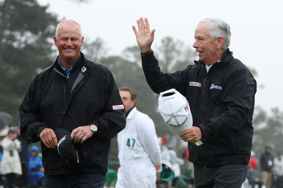 AUGUSTA, GEORGIA - APRIL 08: Sandy Lyle of Scotland and Larry Mize of the United States acknowledge patrons on the 18th green during the continuation of the weather delayed second round of the 2023 Masters Tournament at Augusta National Golf Club on April 08, 2023 in Augusta, Georgia. (Photo by Christian Petersen/Getty Images)