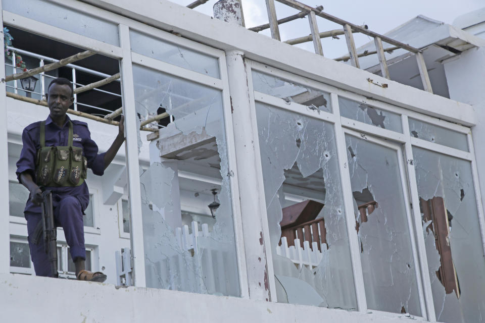 A Somali soldier stands guard with destroyed window of the Pearl Beach hotel in Mogadishu, Somalia, Saturday, June 10, 2023. Extremists attacked the beachside hotel in the capital, Mogadishu Friday and security forces responded at the site as some people remain trapped inside.(AP Photo/ Farah Abdi Warsameh)