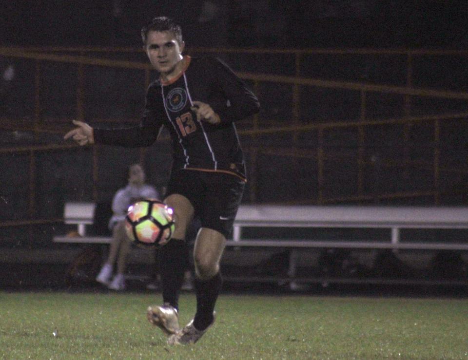 Mandarin midfielder Kristian Palenik (13) delivers a cross-field pass against Nease during a high school boys soccer game on Jan. 4.