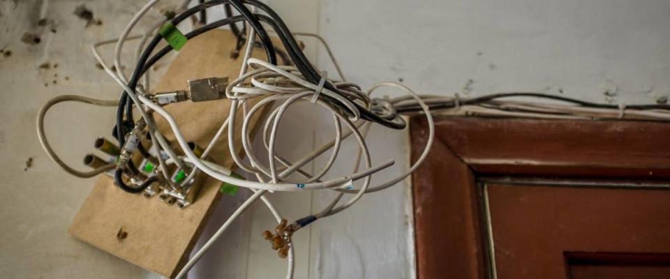 wires hanging from ceiling in old house, during repair