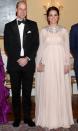 <p>To celebrate their first evening in Norway, the Duchess of Cambridge donned a cape gown by Alexander McQueen. She accessorized the look with jewels borrowed from Her Majesty and a $2,000 sparkly Jimmy Choo clutch. </p>