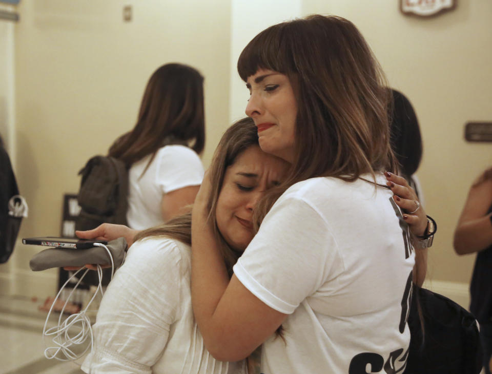 Michelle Sabino, left, and Melissa Floyd, right, opponents of the recently passed legislation to tighten the rules on giving exemptions for vaccinations, console each other after the Legislature approved a companion measure, the Capitol in Sacramento, Calif., Monday, Sept. 9, 2019. Both houses of the Legislature approved the companion bill, SB714, Monday, with changes demanded by Gov Gavin Newsom as a condition of signing the controversial vaccine bill SB276 which was passed by the Legislature last week. Both women say they had infant children injured by vaccinations. (AP Photo/Rich Pedroncelli)