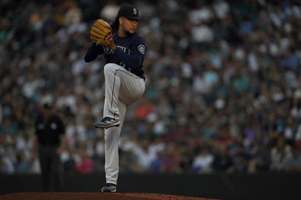 Seattle Mariners starting pitcher Luis Castillo begins his windup in a patch of evening light during the third inning of the team's baseball game against the New York Yankees, Tuesday, Aug. 9, 2022, in Seattle. (AP Photo/Ted S. Warren)