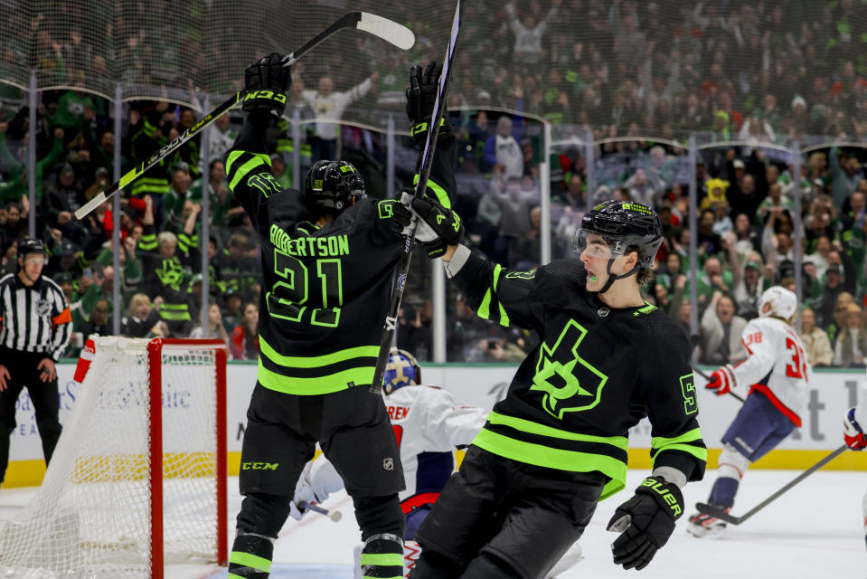 Dallas Stars center Wyatt Johnston, right, celebrates with left wing Jason Robertson (21) after Johnston scored during the first period of an NHL hockey game against the Washington Capitals, Saturday, Jan. 27, 2024, in Dallas. (AP Photo/Gareth Patterson)