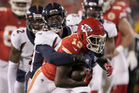 Kansas City Chiefs wide receiver Byron Pringle (13) struggles for yardage as Denver Broncos linebacker Baron Browning defends during the first half of an NFL football game Sunday, Dec. 5, 2021, in Kansas City, Mo. (AP Photo/Charlie Riedel)