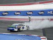 Chase Elliott (9) celebrates after winning a NASCAR Cup Series auto race at Charlotte Motor Speedway, Sunday, Sept. 29, 2019, in Concord, N.C. (AP Photo/Mike McCarn)