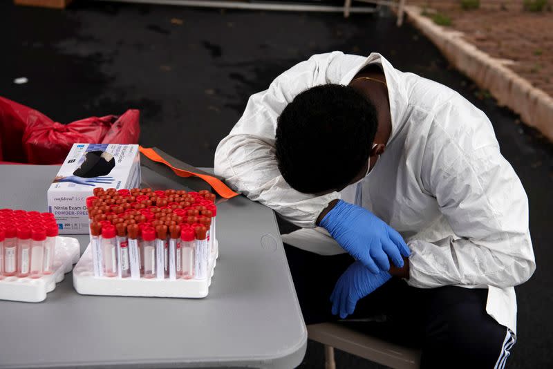 FILE PHOTO: People wait in long lines for COVID-19 testing in Houston