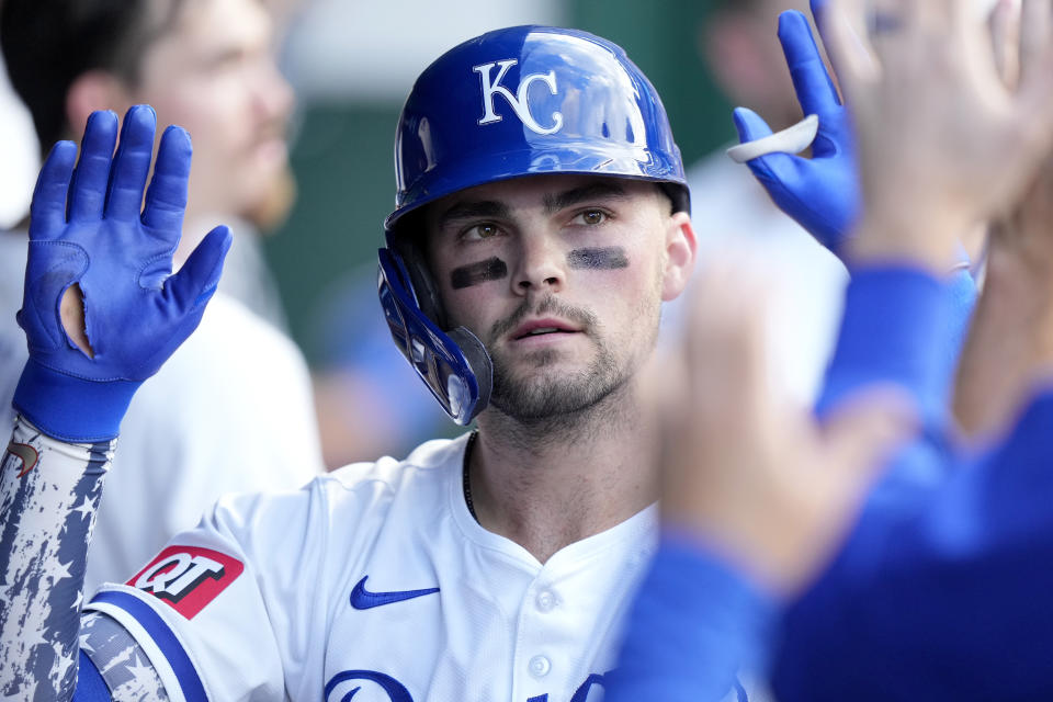 Kansas City Royals' Michael Massey celebrates in the dugout after hitting a solo home run during the second inning of a baseball game against the Tampa Bay Rays Thursday, July 4, 2024, in Kansas City, Mo. (AP Photo/Charlie Riedel)