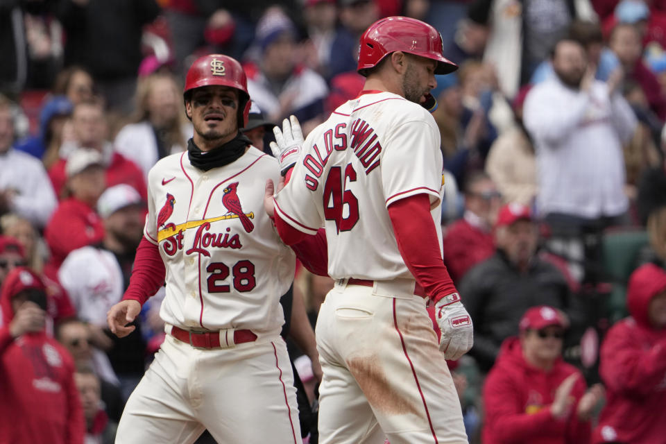 St. Louis Cardinals' Nolan Arenado (28) and Paul Goldschmidt (46) celebrate after scoring during the third inning of a baseball game against the Toronto Blue Jays Saturday, April 1, 2023, in St. Louis. (AP Photo/Jeff Roberson)