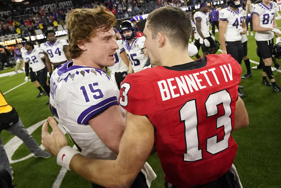 Georgia quarterback Stetson Bennett (13) speaks with TCU quarterback Max Duggan (15) after the national championship NCAA College Football Playoff game, Monday, Jan. 9, 2023, in Inglewood, Calif. Georgia won 65-7. (AP Photo/Ashley Landis)