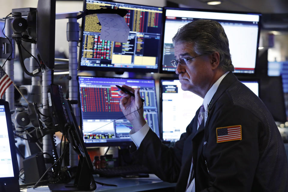 Trader Daniel Krieger works on the floor of the New York Stock Exchange, Wednesday, Aug. 14, 2019. Stocks are falling sharply after the bond market threw up another warning flag on the economy. (AP Photo/Richard Drew)