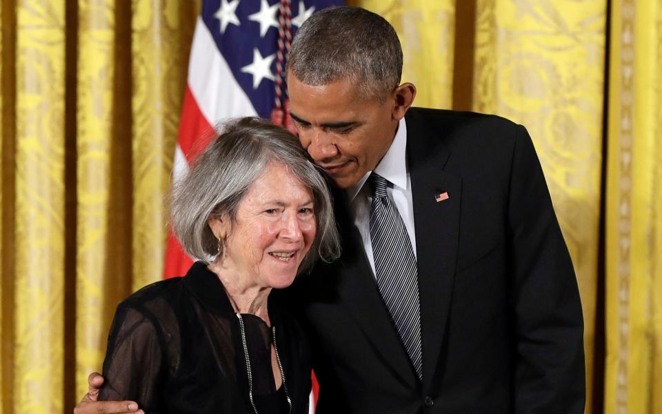 President Barack Obama embraces poet Louise Gluck - AP