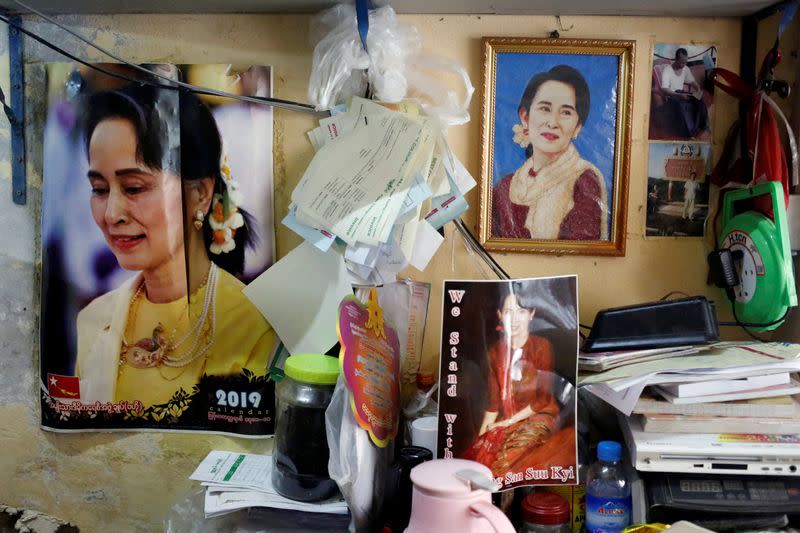 FILE PHOTO: Photos of Myanmar State Counselor Aung San Suu Kyi are seen in a shop in Yangon