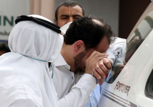 A father of one of the victims cries for the loss of his son outside Doha's Villaggio Mall after a fire broke out inside the Gulf emirate's upscale shopping centre, killing at least 19 people, including 13 children