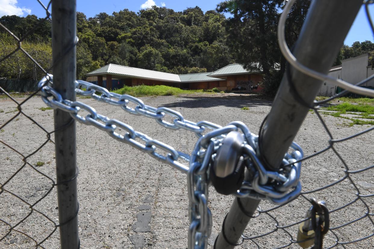 A vacant building stands on a fenced-off lot Monday. The Camino de Salud housing development is proposed to provide 49 affordable housing units on the site in the unincorporated area of Mira Monte just outside Ojai.