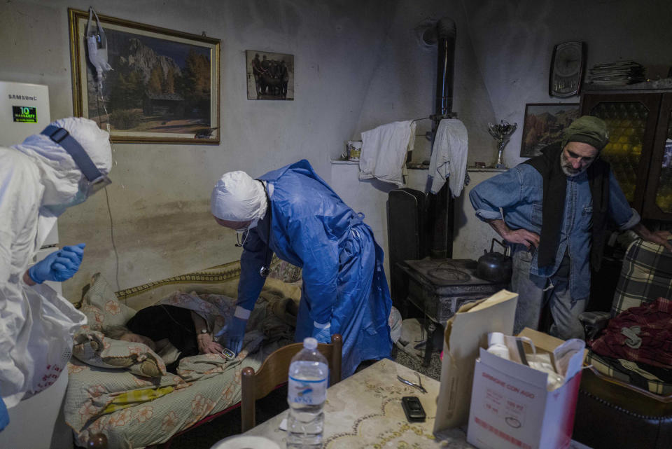 Cavanna and a colleague during a house visit on March 26. His teams bring patients medicine and a device that monitors the levels of oxygen in the blood, which they return after they’ve recovered. In more critical cases Cavanna leaves tanks of oxygen. | Gabriele Micalizzi—Cesura