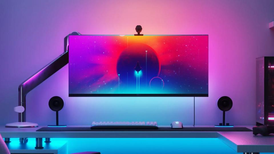 Image of monitor with bright colorful light coming from behind it