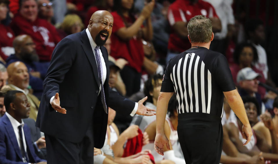 Indiana head coach Mike Woodson, left, talks to a referee during the second half of an NCAA college basketball game against Rutgers in Piscataway, N.J., Saturday, Dec. 3, 2022. (AP Photo/Noah K. Murray)