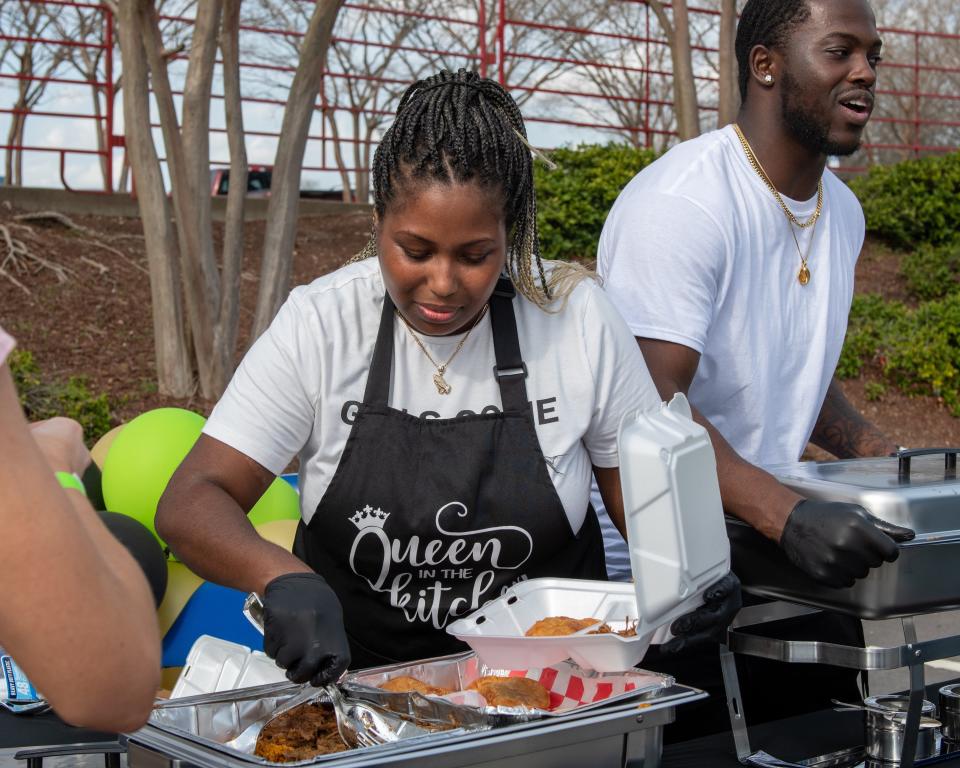 Vendors serve food at the Fayetteville Eats festival, March 19, 2022.