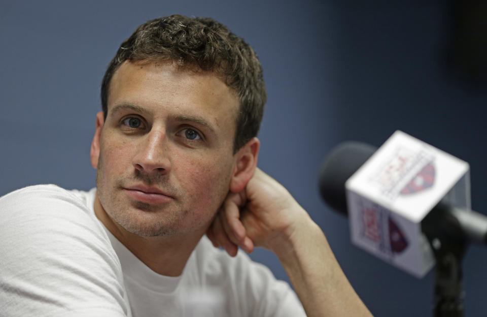 FILE - In this May 12, 2016, file photo, Ryan Lochte listens to a question from the media in Charlotte, N.C. Lochte’s attorney says the swimmer is seeking help for poor decision making that occurs when alcohol is involved, but the 12-time Olympic medalist is not in a treatment facility and he continues to train for a shot at the 2020 Tokyo Games. (AP Photo/Chuck Burton, File)