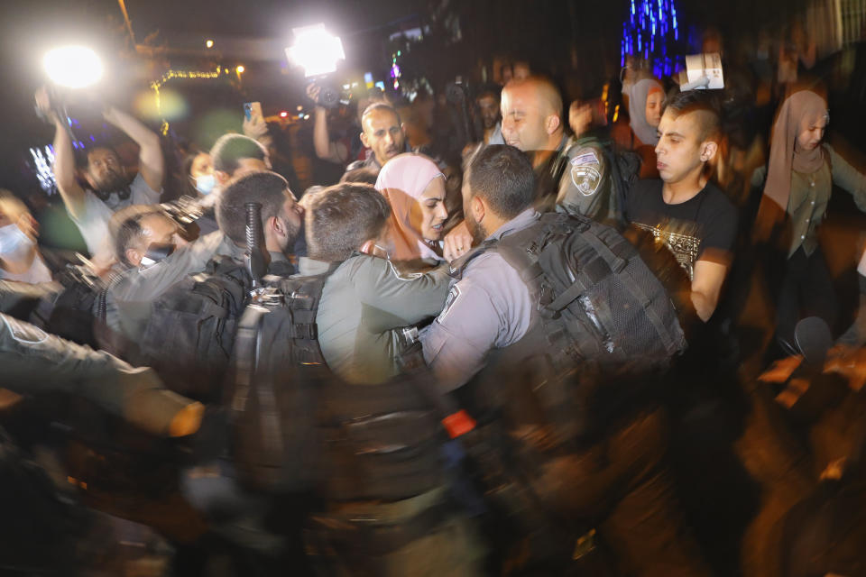 Palestinians scuffle with Israeli police officers during a protest against the planned evictions of Palestinian families in the Sheikh Jarrah neighborhood of east Jerusalem, Tuesday, May 4, 2021. (AP Photo/Mahmoud Illean)