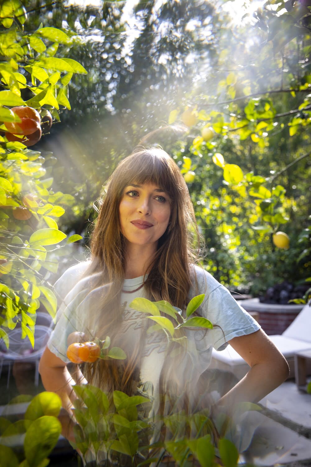 Actress Dakota Johnson photographed under a tree