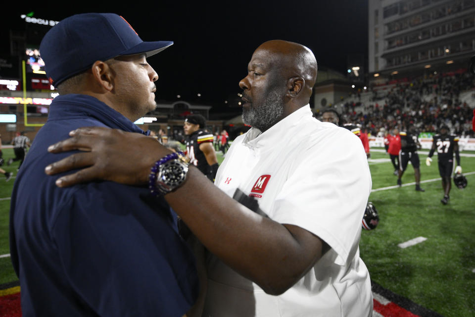 Maryland coach Mike Locksley, right, meets with Virginia coach Tony Elliott after an NCAA college football game Friday, Sept. 15, 2023, in College Park, Md. (AP Photo/Nick Wass)