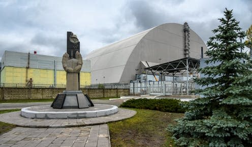 <span class="caption">The memorial to the Chernobyl disaster in front of the reactor, now encased in its new containment shield.</span> <span class="attribution"><a class="link " href="https://www.flickr.com/photos/franganillo/38342070546/" rel="nofollow noopener" target="_blank" data-ylk="slk:Jorge Franganillo;elm:context_link;itc:0;sec:content-canvas">Jorge Franganillo</a>, <a class="link " href="http://creativecommons.org/licenses/by/4.0/" rel="nofollow noopener" target="_blank" data-ylk="slk:CC BY;elm:context_link;itc:0;sec:content-canvas">CC BY</a></span>