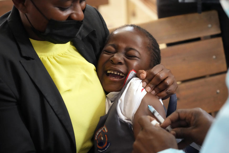 A young girl reacts while been vaccinated against measles at a clinic in Harare, Zimbabwe, Thursday, Sept. 15, 2022. Church members in Zimbabwe are getting their children vaccinated against measles in secret amid a deadly outbreak. It's to avoid being shunned by religious leaders who are opposed to modern medicine. (AP Photo/Tsvangirayi Mukwazhi)