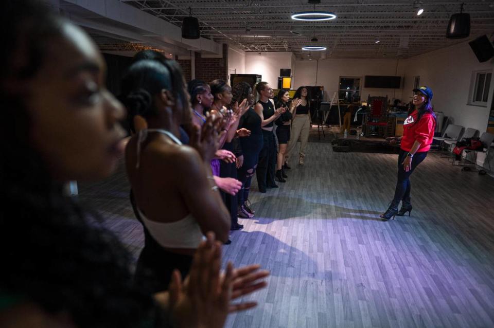 Elaina Paige Thomas, right, speaks with a group of dancers at the end of her class on Wednesday, Sept. 27, 2023, at The Next Paige in Kansas City. “I believe that learning Run the World for all women sets us up for success, for confidence, to rebuild your strength,” Paige Thomas said. “Because at the end of the day, women do run the world.” Zachary Linhares/zlinhares@kcstar.com