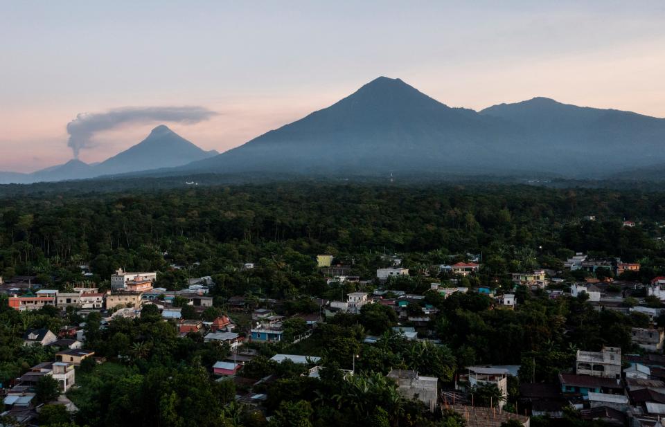 Volcanoes to the east of La Ceiba, Guatemala, are seen during a sunrise in October. Young men often leave their Mayan villages for the U.S. in search of employment to help their families.