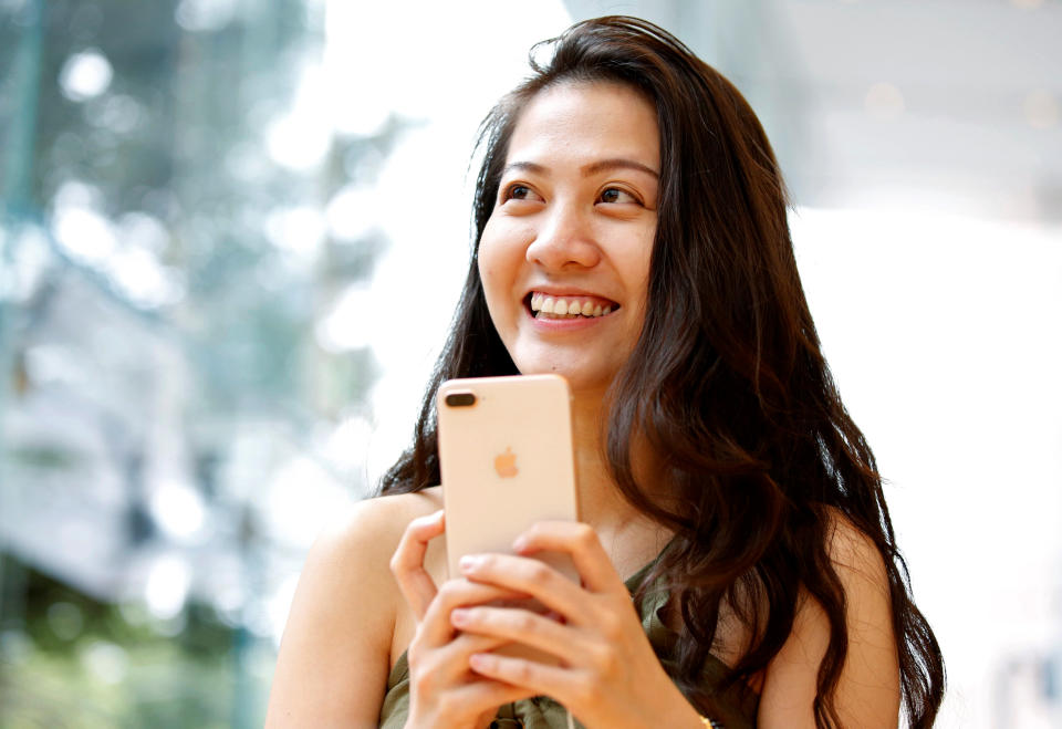 A woman holds Apple’s new iPhone 8 Plus after it went on sale at the Apple Store in Tokyo’s Omotesando shopping district