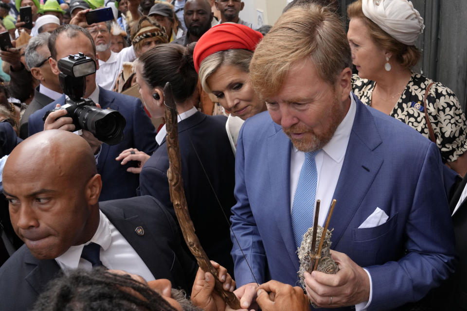 Khoisan protesters surround King Willem Alexander and Queen Maxima of the Netherlands at the Iziko Slave Lodge museum in Cape Town during their state visit to South Africa Friday, Oct. 20, 2023. The king and queen of the Netherlands were confronted by angry protesters in South Africa on a visit Friday to a monument that traces part of their country's involvement in slavery as a colonial power 300 years ago. (AP Photo/Nardus Engelbrecht)