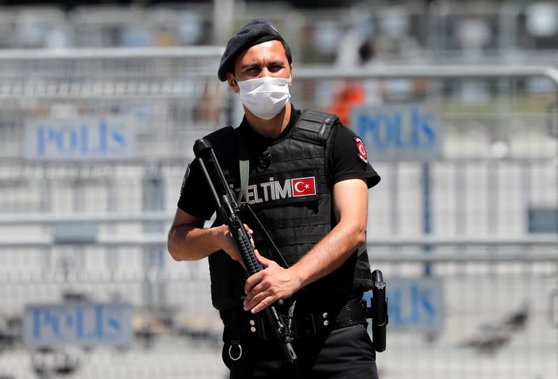 A Turkish riot police officer stands guard in front of the Justice Palace in Istanbul