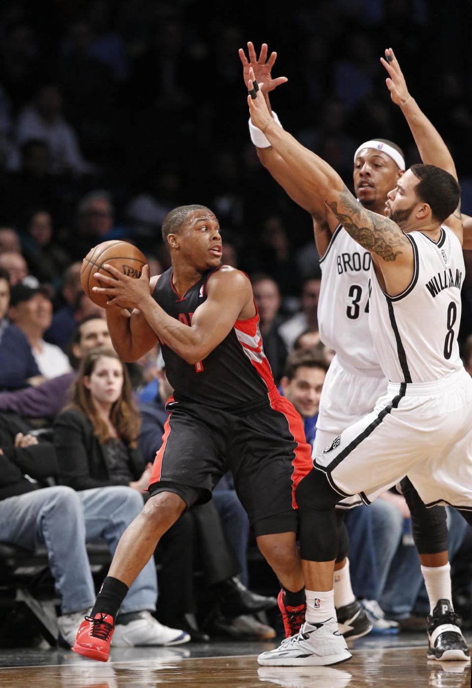 Brooklyn Nets forward Paul Pierce (34) and Nets guard Deron Williams (8) defend Toronto Raptors guard Kyle Lowry, left, in the first half of an NBA basketball game, Monday, Jan. 27, 2014, in New York. (AP Photo/Kathy Willens)