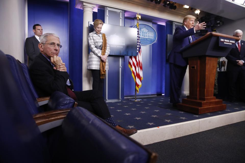 Dr. Anthony Fauci, then director of the National Institute of Allergy and Infectious Diseases, left, listens as President Donald Trump speaks during a coronavirus task force briefing at the White House on April 5, 2020, in Washington.