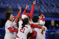 Members of team Japan celebrate after a softball game against the United States at the 2020 Summer Olympics, Tuesday, July 27, 2021, in Yokohama, Japan. Japan won 2-0. (AP Photo/Sue Ogrocki)