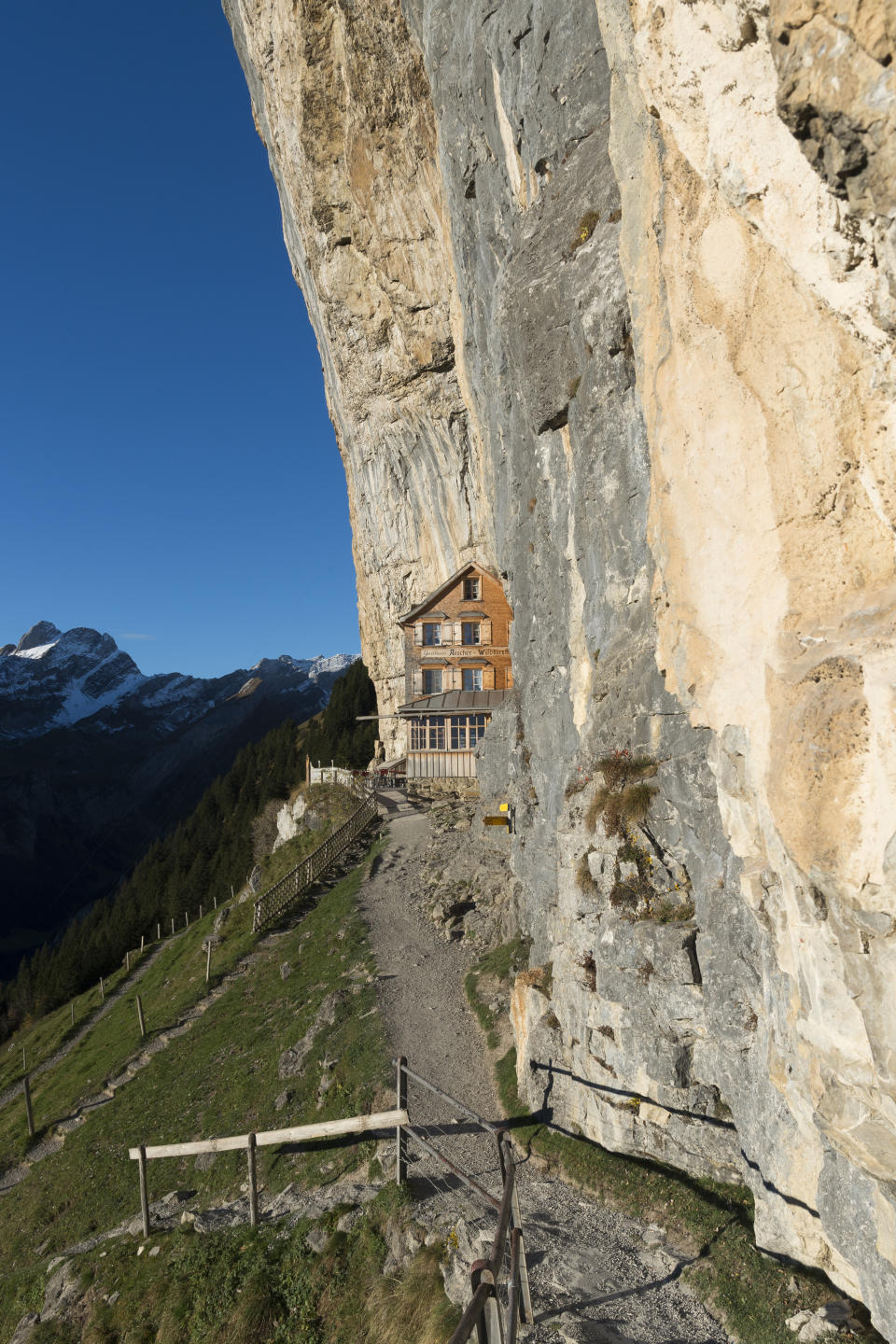 FILE - The Oct. 27, 2015 file photo shows a view of the Aescher mountain hut in Weissbad, Switzerland. The Gasthaus Aescher, built into a cliff above a valley in northeastern Switzerland, has been run by the same family since 1987. Authorities in Appenzell-Innerrhoden canton said Monday, Aug. 20, 2018 that the current tenants, Nicole and Bernhard Knechtle-Fritsche, are giving up the lease at the end of the 2018 season. (Gian Ehrenzeller/Keystone via AP, file)