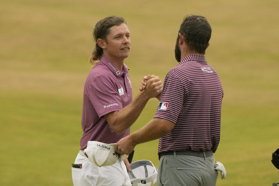 Cameron Smith, of Australia, left, shakes hands with Cameron Young of the US after their final round of the British Open golf championship on the Old Course at St. Andrews, Scotland, Sunday July 17, 2022. (AP Photo/Gerald Herbert)