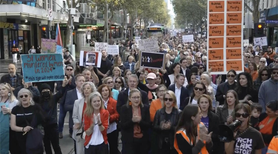 In this image made from video provided by AUBC, people march and shout slogans during a protest against gender-based violence, in Melbourne, Australia, Sunday, April 28, 2024. Thousands of people rallied across Australia on Sunday, demanding action to end gender-based violence in the country. (AUBC via AP)