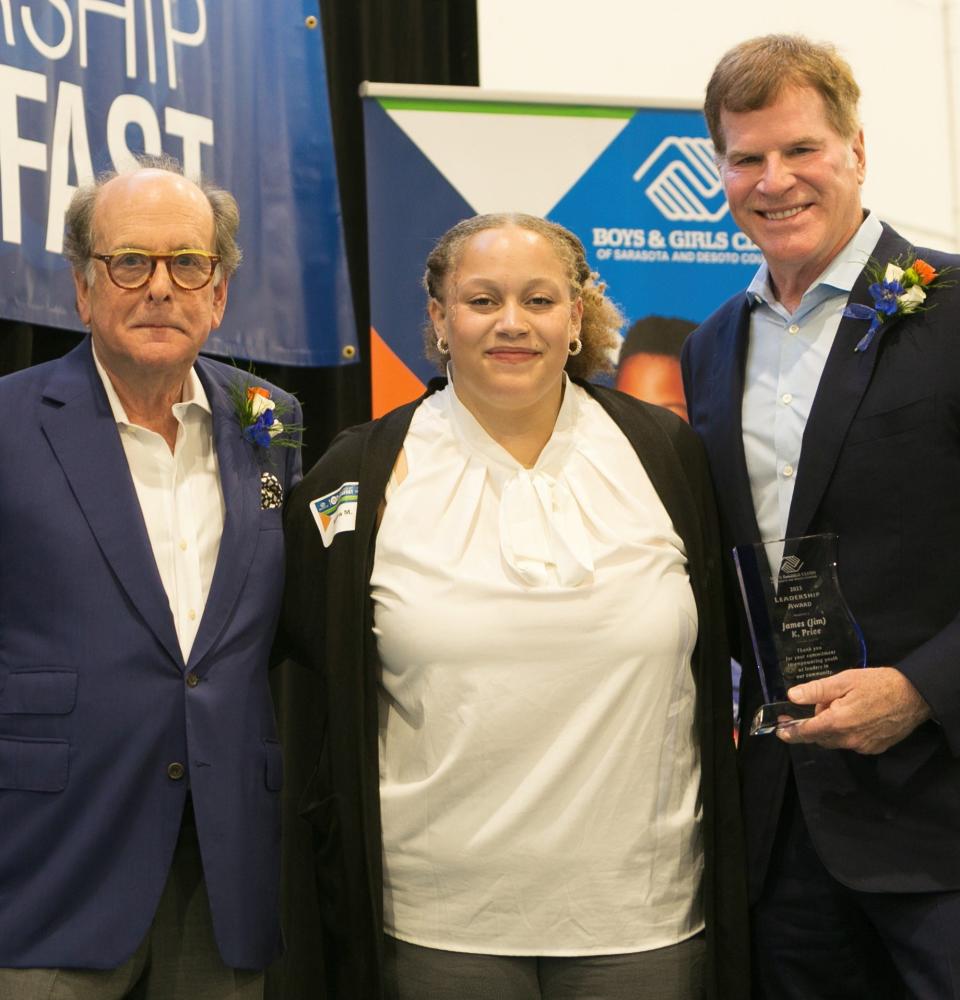 Richard Perlman and James Price, co-founders of ExamWorks Group, receive their BGCSDC Leadership Award from Sierra M., a senior at Riverview High School.