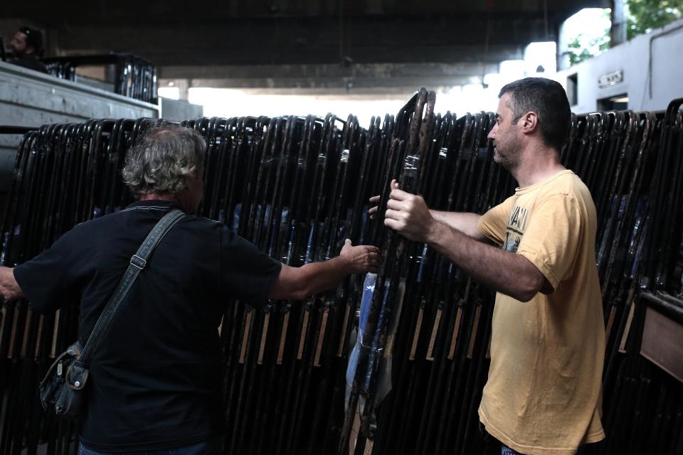 Municipal workers store booths in a warehouse in Athens, Greece, on July 2, 2015, in preparation for the upcoming referendum.