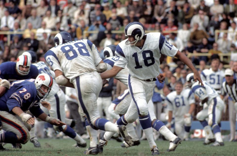 Sep 27, 1970; Buffalo, NY, USA; FILE PHOTO; 
Los Angeles Rams quarterback (18) Roman Gabriel hands off to running back (88) Pat Curran as Buffalo Bills defensive tackle (78) Jim Dunaway breaks through the line at War Memorial Stadium. Mandatory Credit: Photo By Manny Rubio-USA TODAY Sports © Copyright Manny Rubio