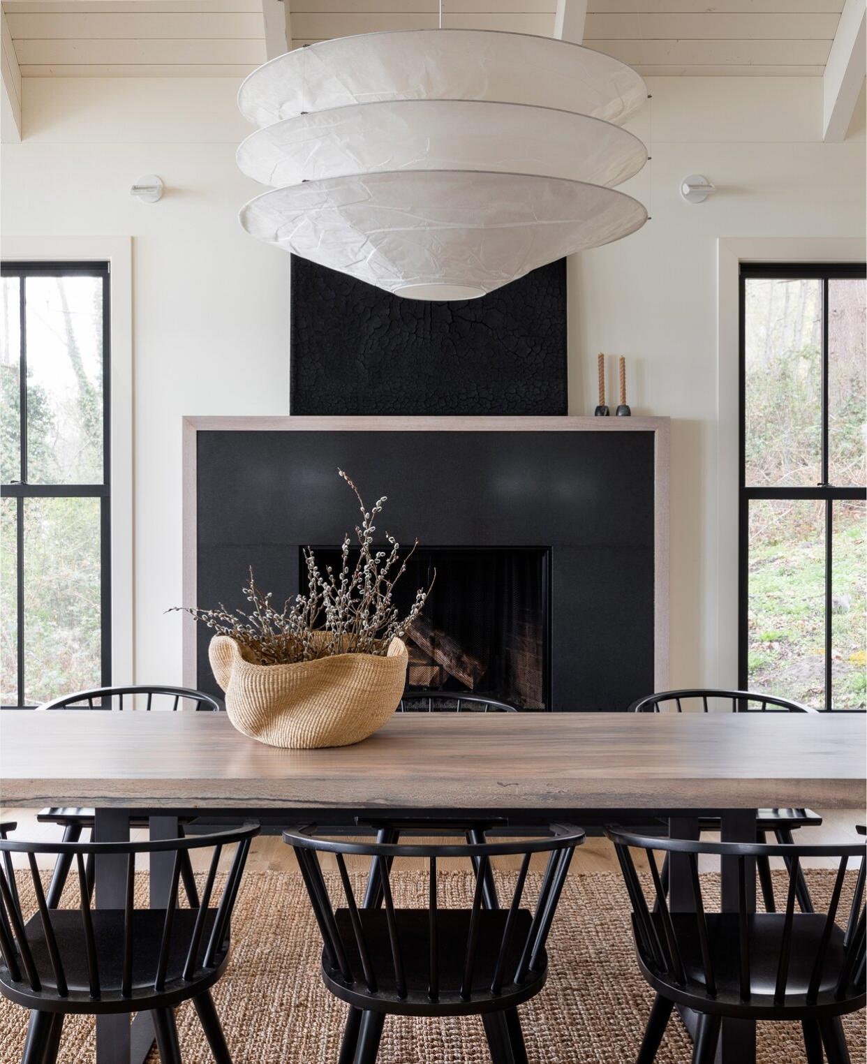 neutral-colored dining room with black fireplace