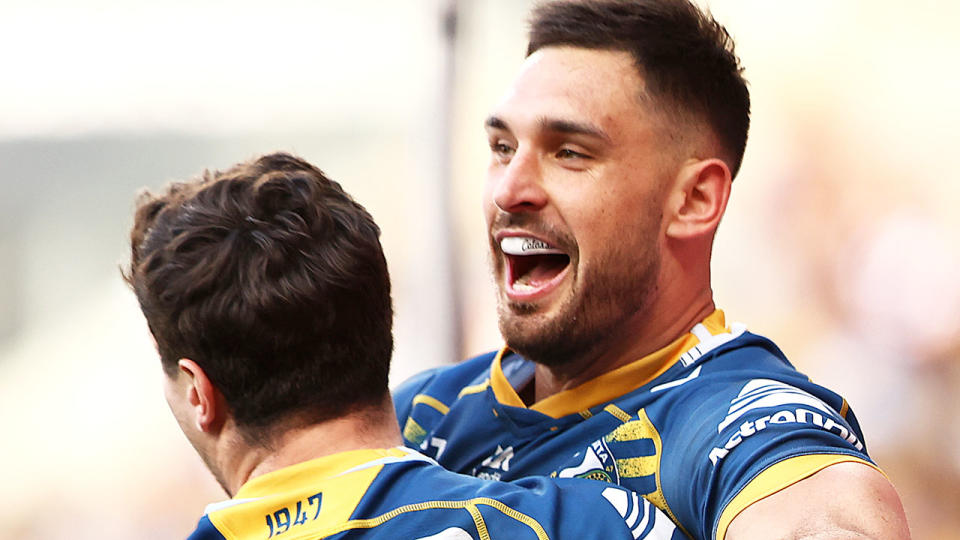 Ryan Matterson celebrates an NRL try with a Parramatta Eels teammate.