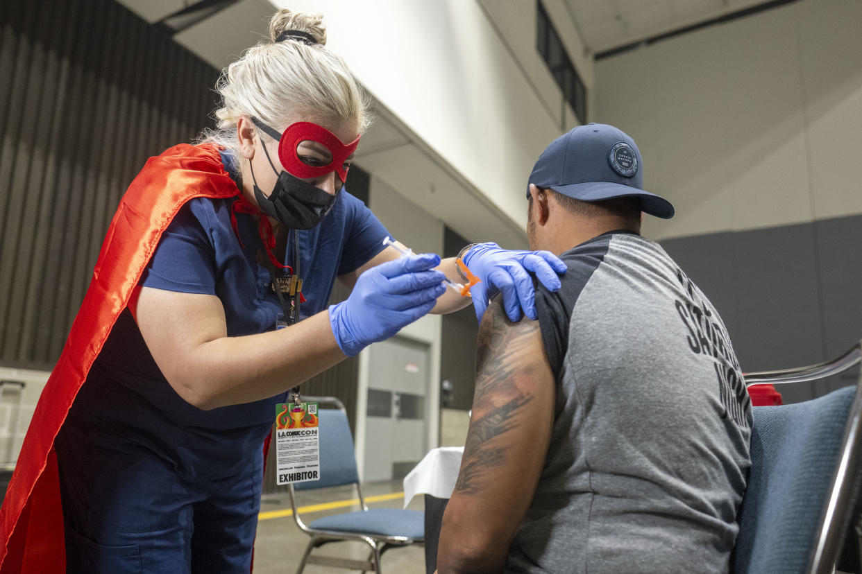 Los Angeles, CA - December 02: Los Angeles County Department of Public Health Nurse Yessica Carrillo administers a COVID-19 booster to Miguel Torres during the  Los Angeles Comic Con at the Los Angeles Convention Center Friday, Dec 2, 2022. The Los Angeles County Department of Public Health partnered with Los Angeles Comic Con to provide ticketed guests and staff with free vaccinations of both the updated COVID-19 booster and influenza vaccine. (Photo by Hans Gutknecht/MediaNews Group/Los Angeles Daily News via Getty Images)